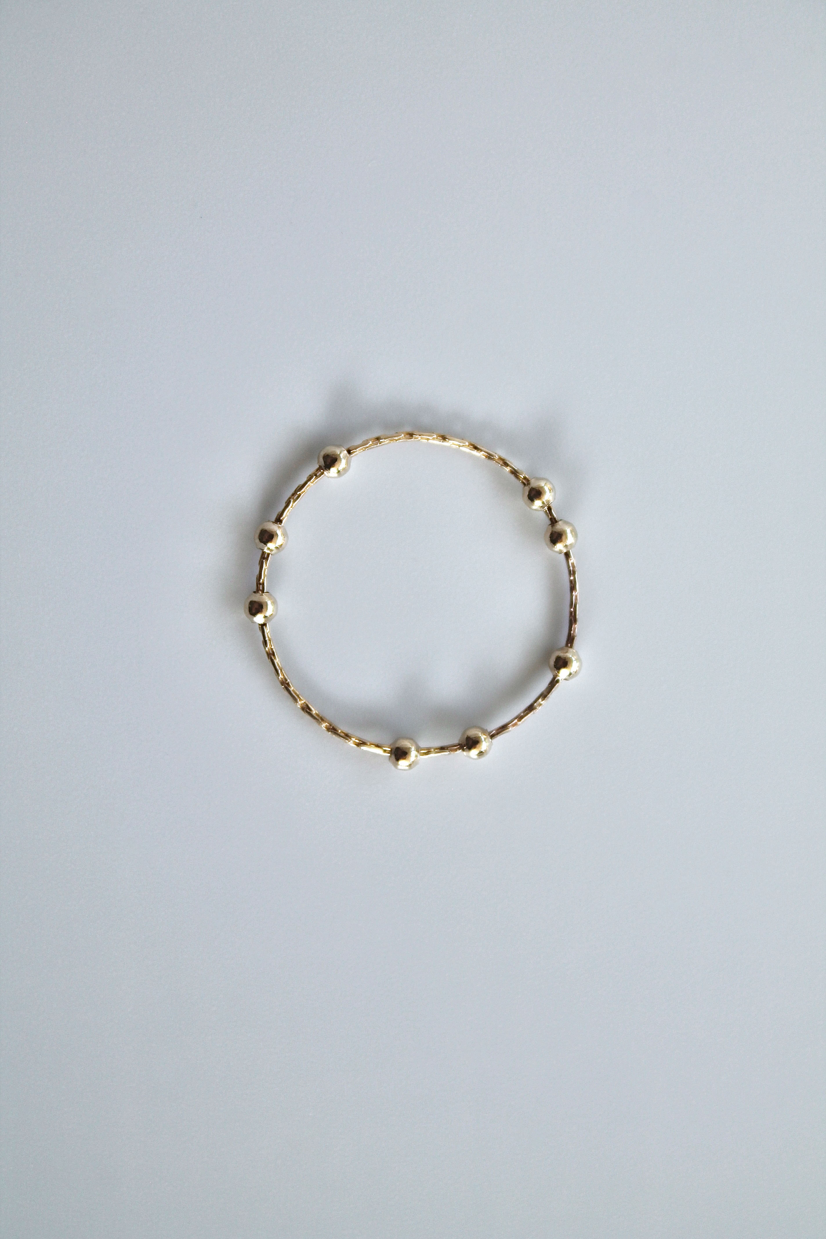 gold fidget spinner ring on a white background