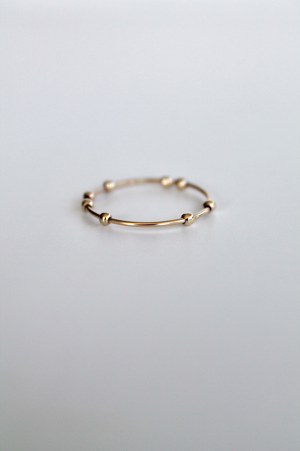 Gold ring on a light gray background