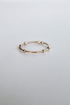 Gold ring on a light gray background