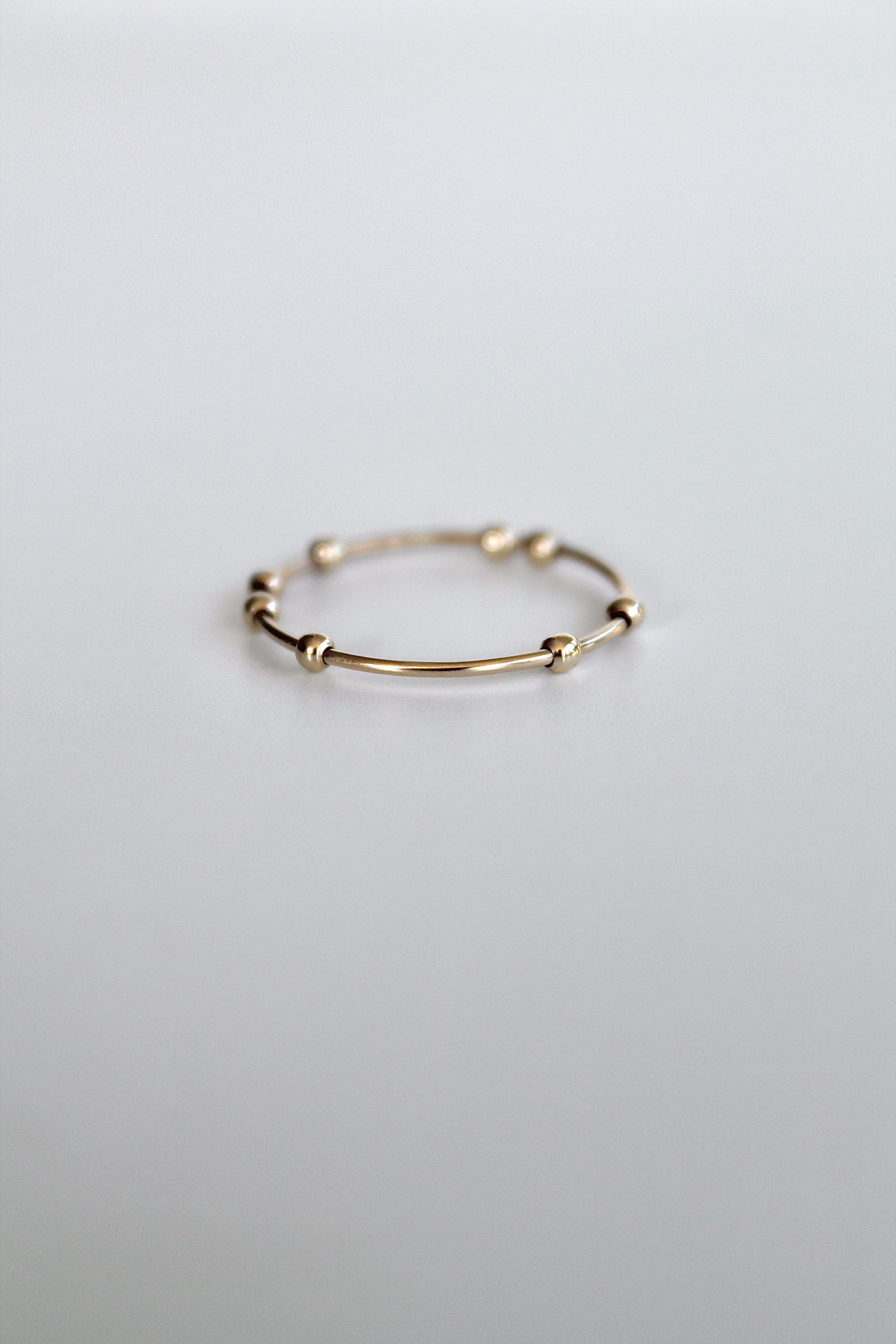 Gold ring on a light gray background