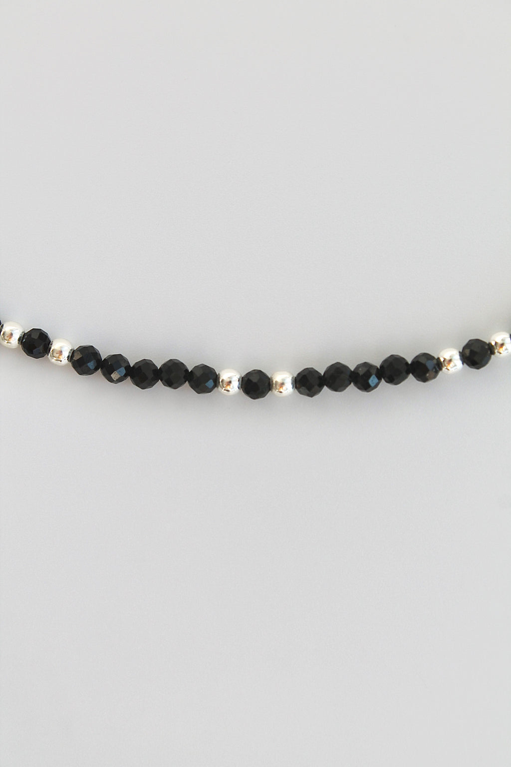 black and silver beaded bracelet on white background