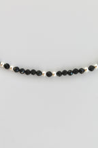 black and silver beaded bracelet on white background