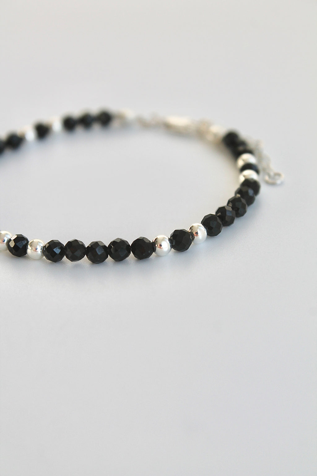 black and silver beaded bracelet on a white background