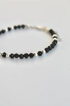 black and silver beaded bracelet on a white background