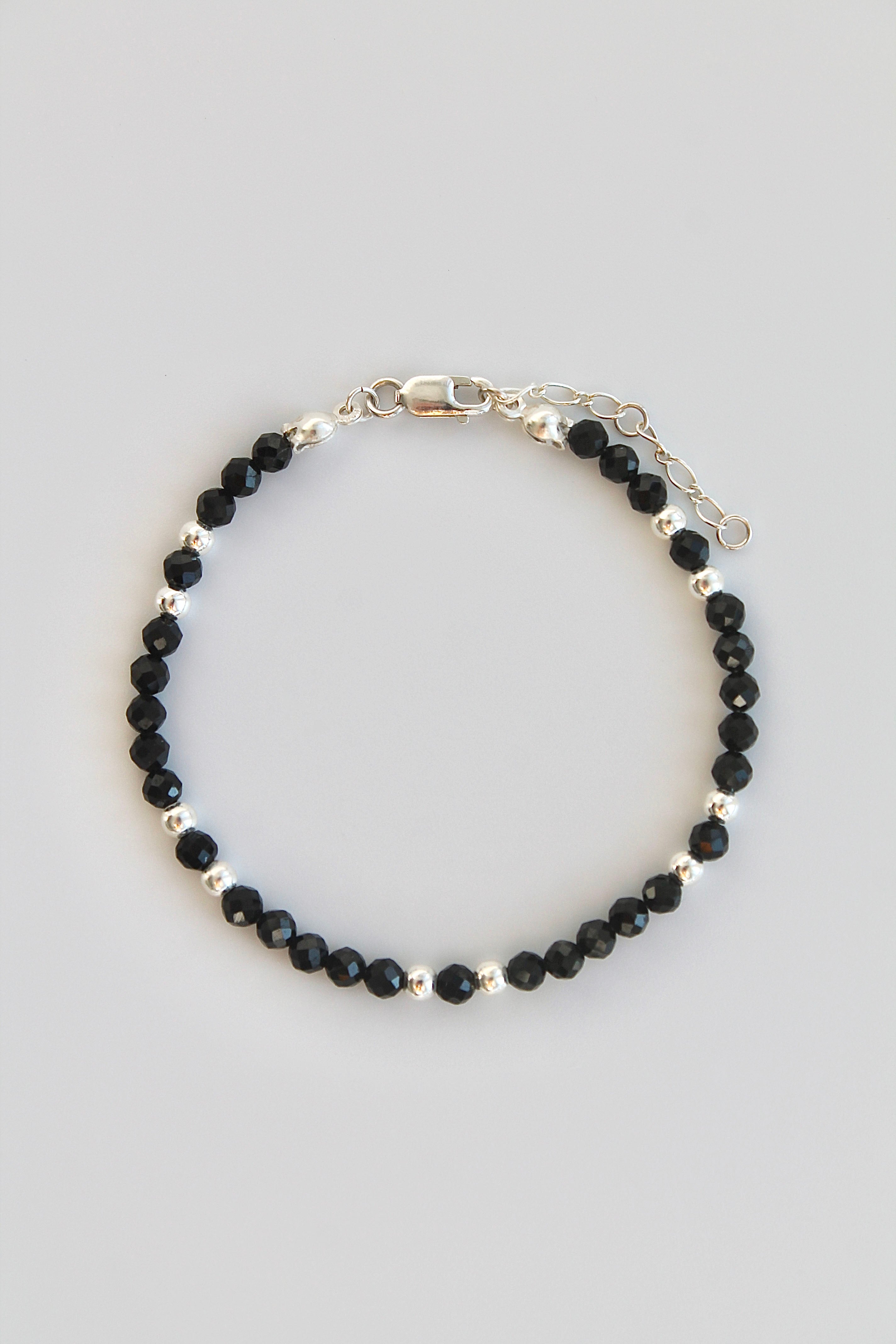 black and silver beaded bracelet on white background