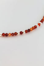 carnelian and silver beaded bracelet on a white background