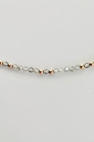 3mm round labradorite gemstone and gold bead bracelet on a white background 