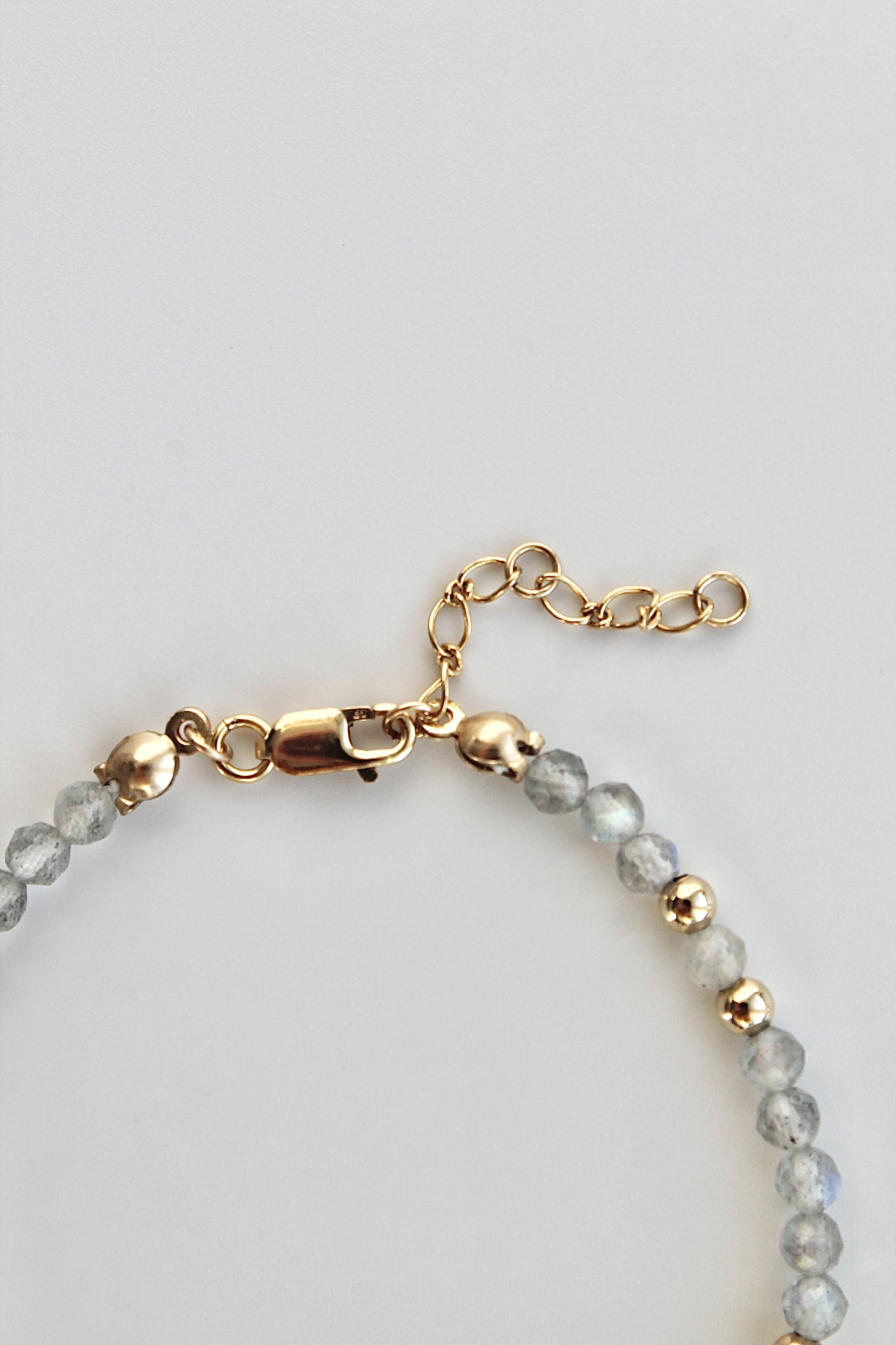 3mm labradorite gemstone and gold bead bracelet with close-up of the clasp and extender chain on a white background