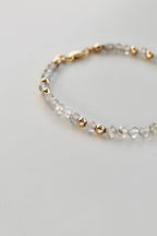 3mm labradorite gemstone and gold bead bracelet on a white background