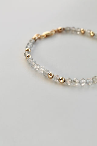 3mm labradorite gemstone and gold bead bracelet on a white background