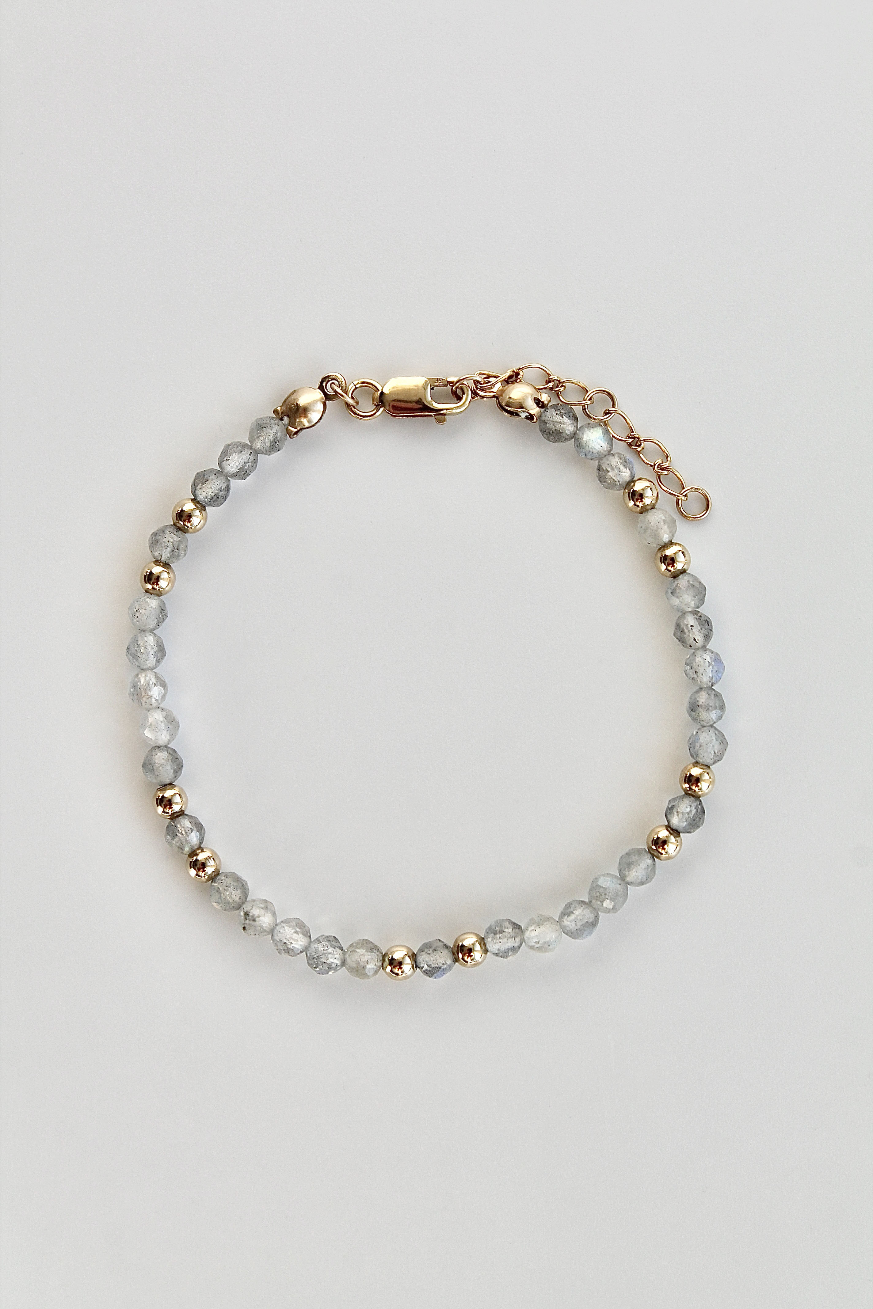 3mm labradorite gemstone and gold bead bracelet overview with gold clasp on a white background