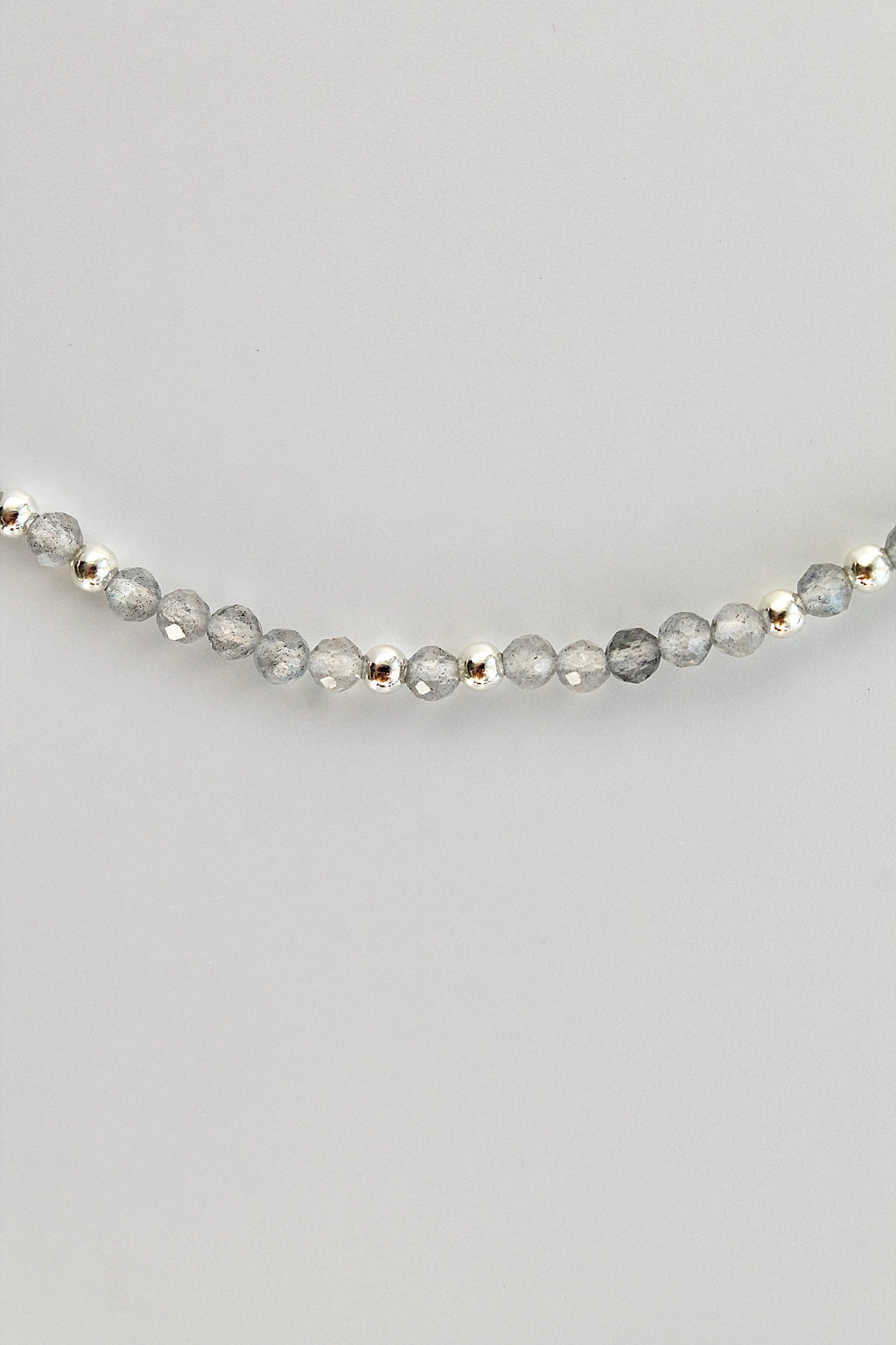 3mm labradorite gemstone and silver bead bracelet on a white background