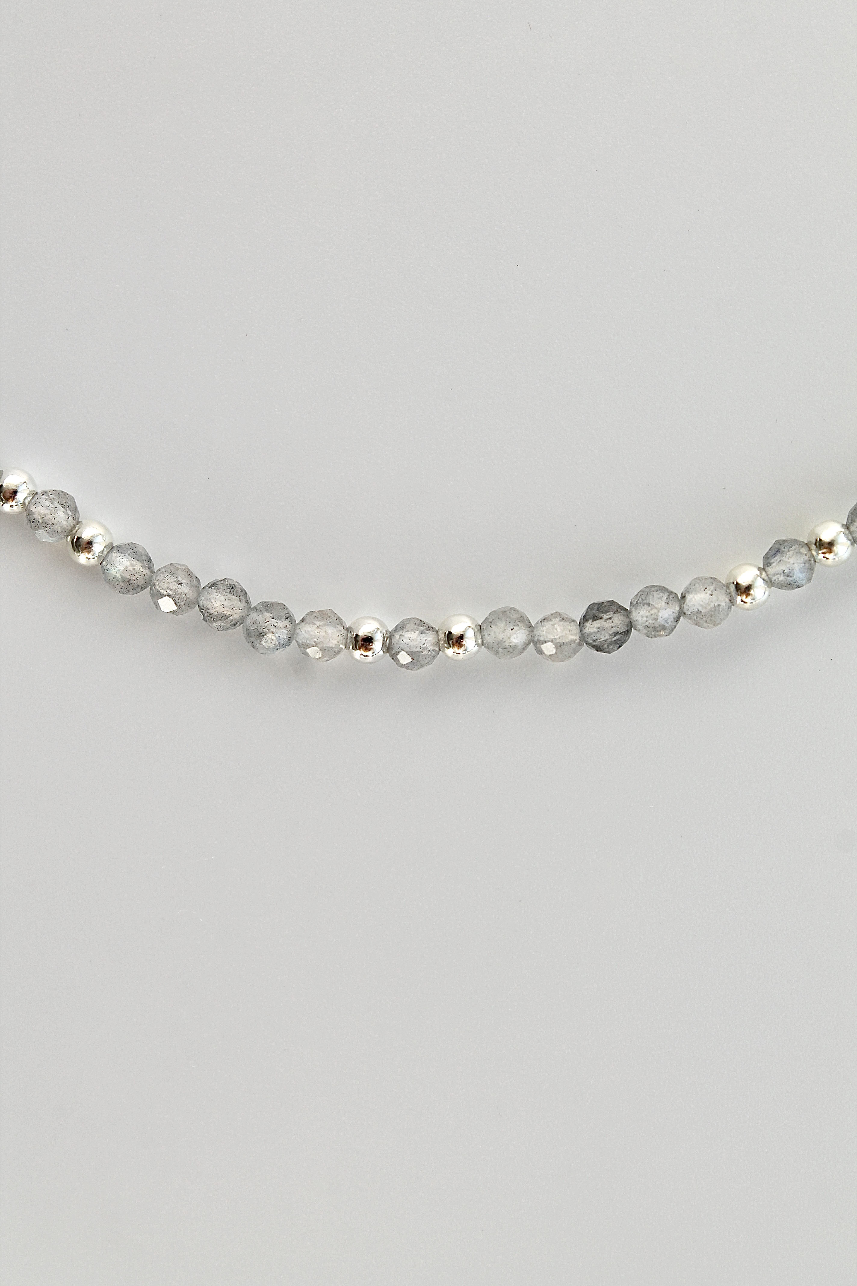 3mm labradorite gemstone and silver bead bracelet on a white background
