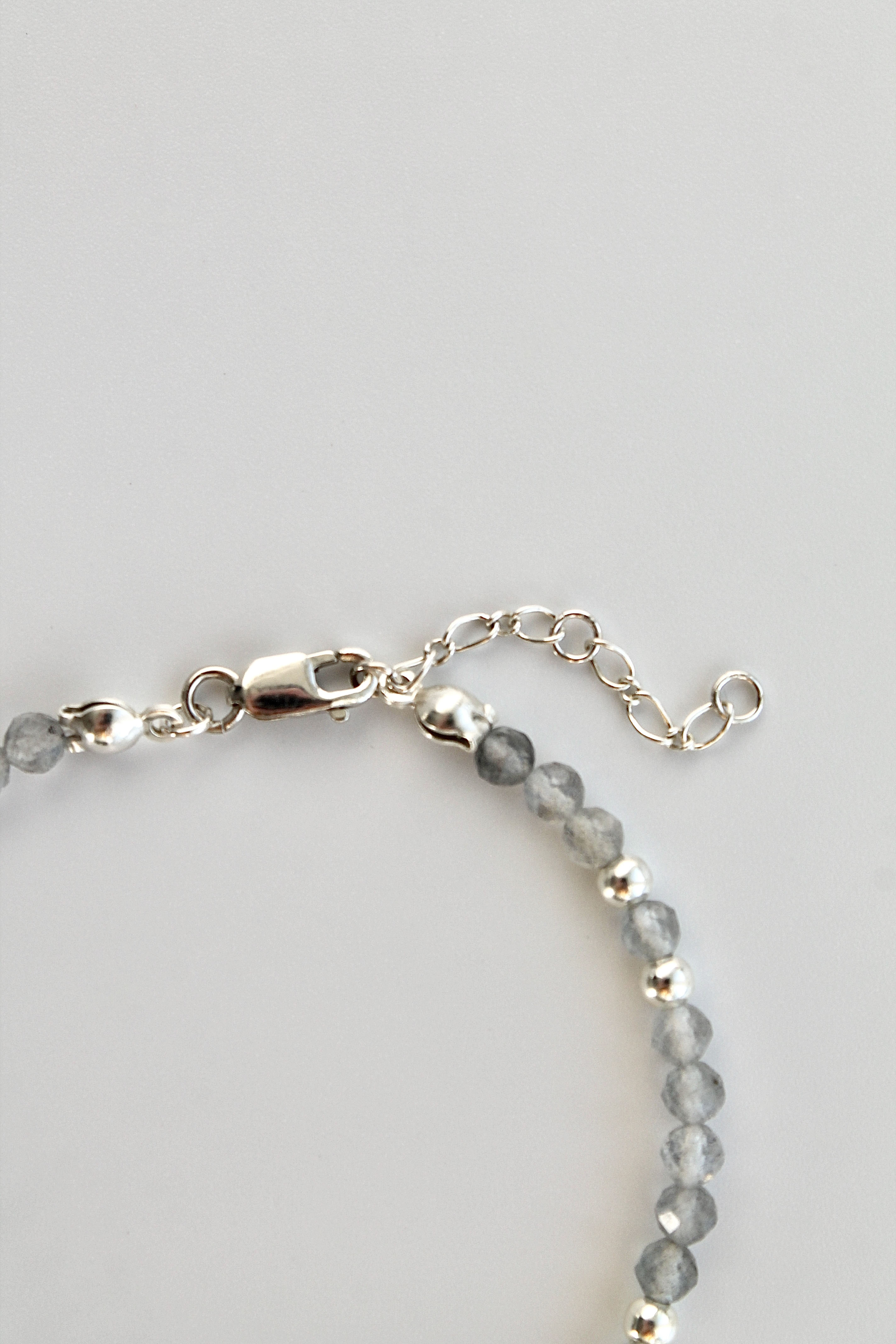 3mm labradorite gemstone and silver bead bracelet with a close-up of the clasp and extender chain on a white background