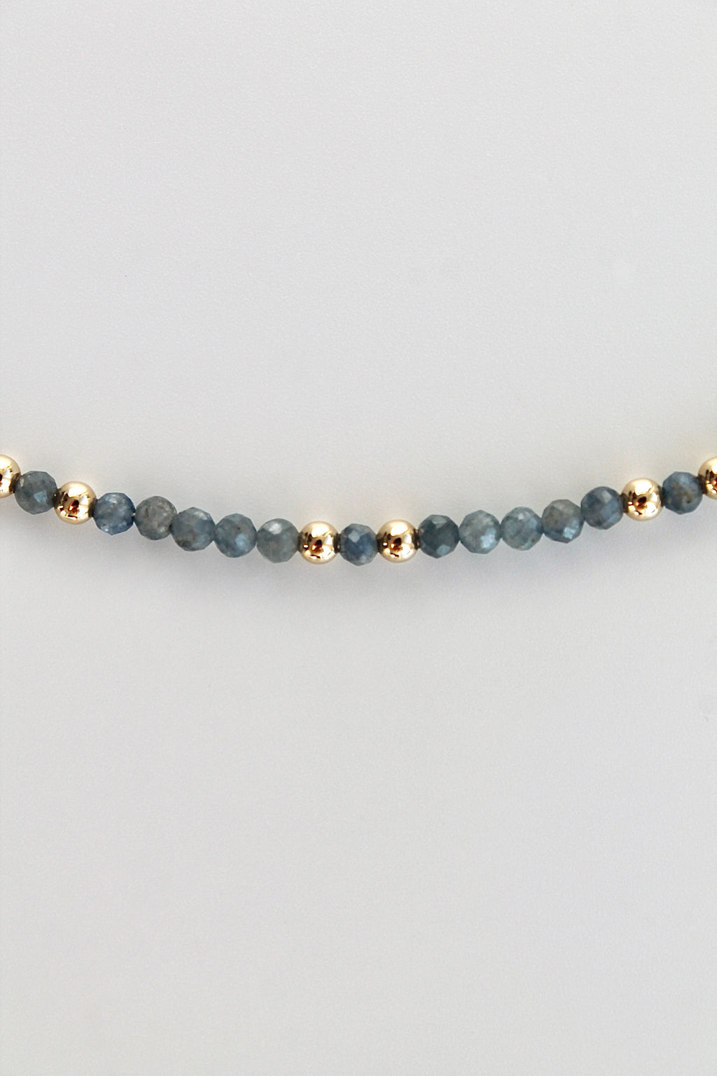 3mm sapphire gemstone gold bead bracelet on a white background
