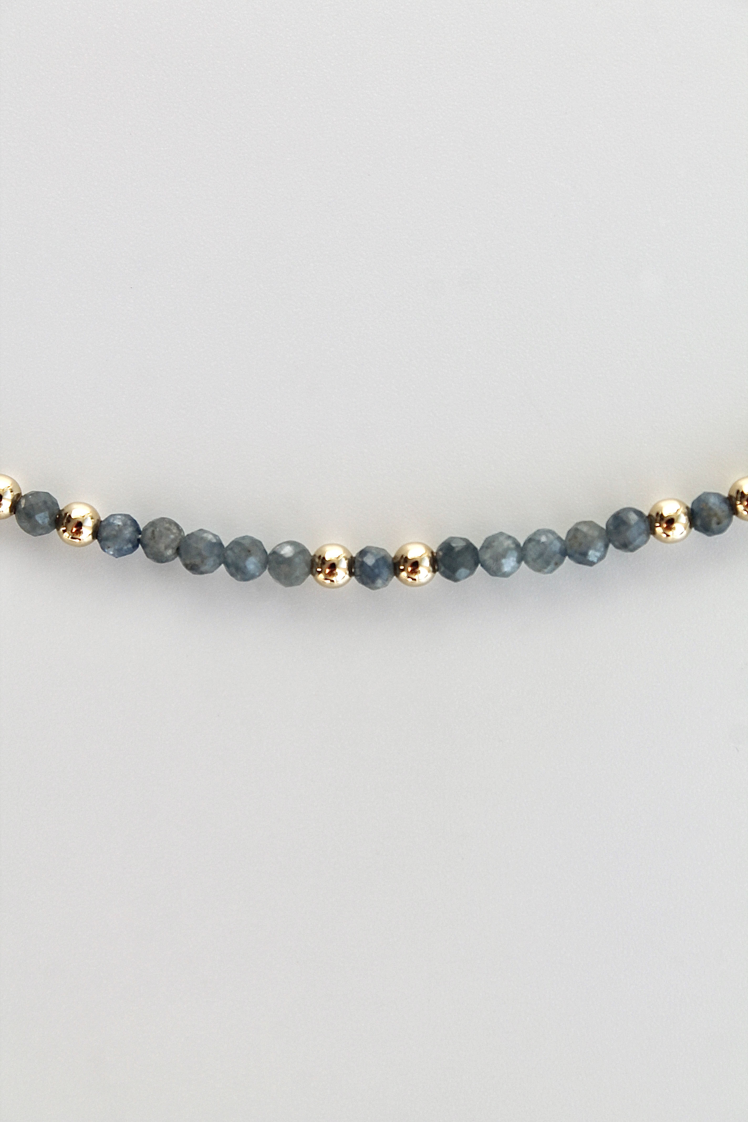 3mm sapphire gemstone gold bead bracelet on a white background