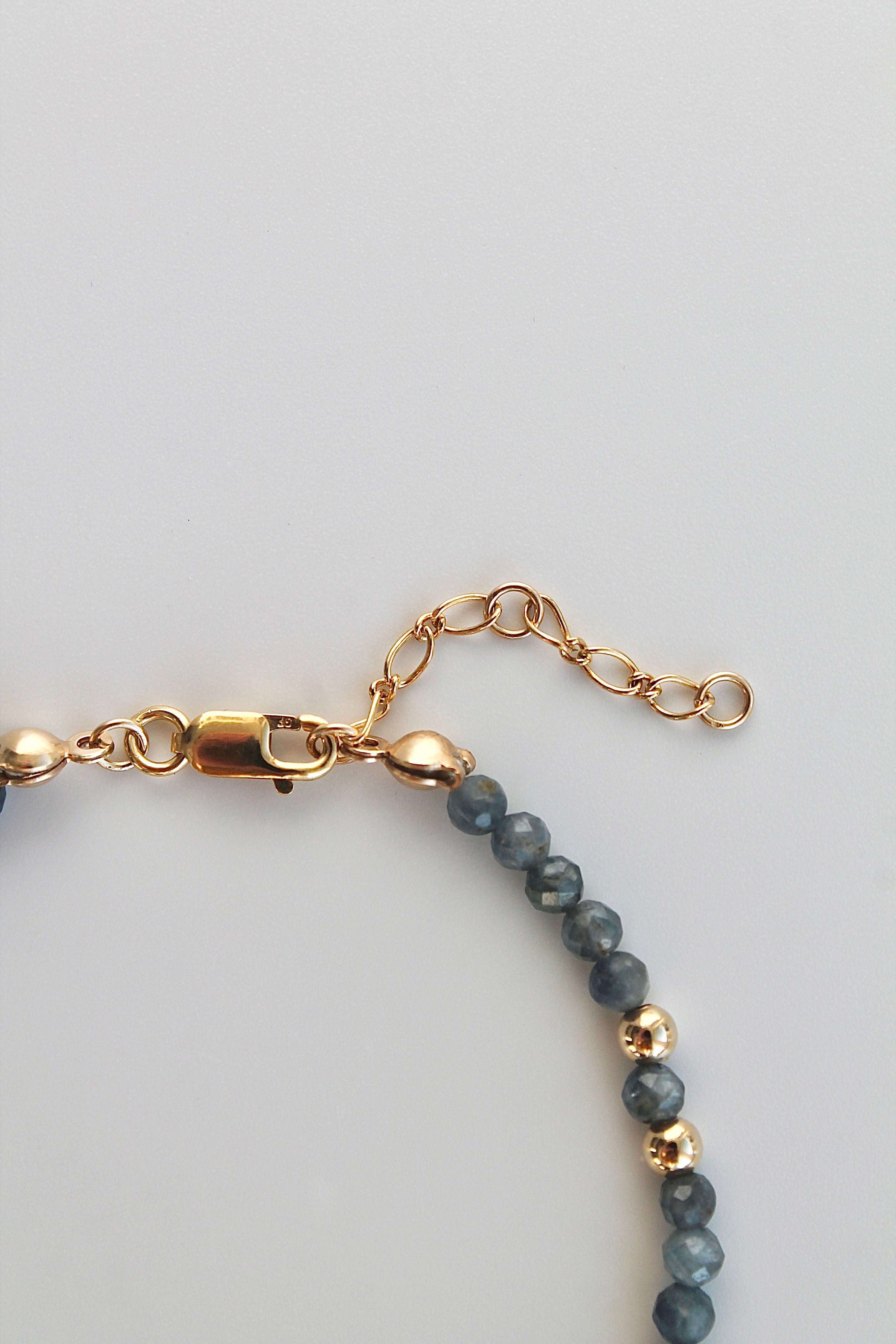 3mm sapphire gemstone gold bead bracelet close-up with clasp and extender chain on a white background