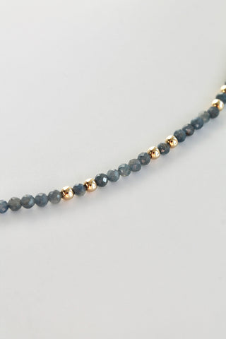 3mm sapphire gemstone gold bead bracelet close-up on a white background