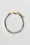 3mm sapphire gemstone gold bead bracelet overview with gold clasp on a white background