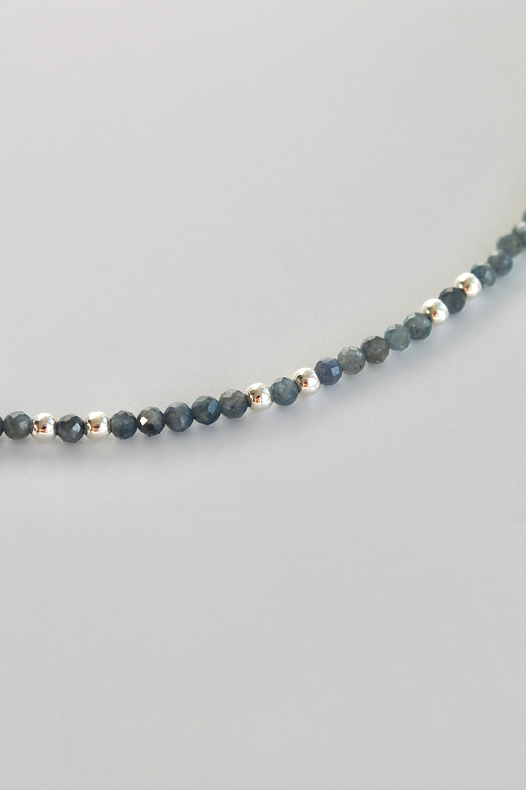 3mm sapphire gemstone silver bead bracelet close-up on a white background
