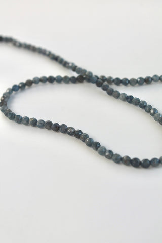 string of 3mm sapphire gemstones on a white background